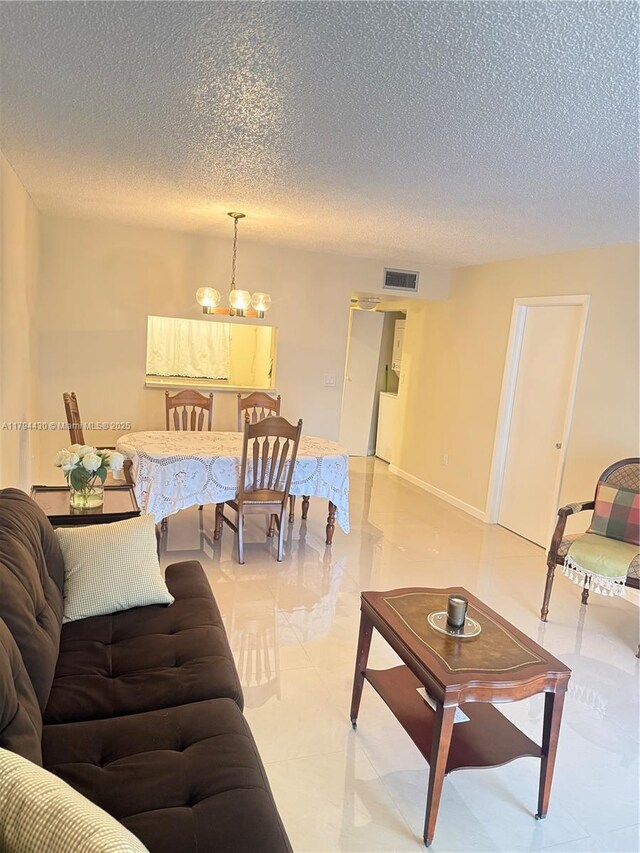 901 Colony Point Cir Unit 217, Pembroke Pines, FL 33026 - living room featuring a textured ceiling and visible vents