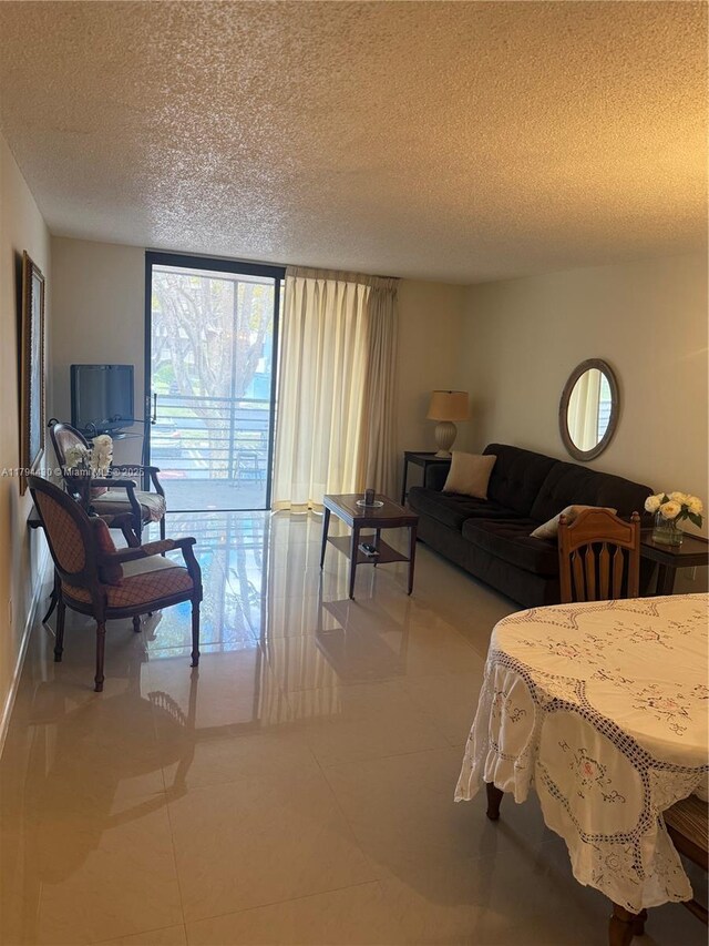 901 Colony Point Cir Unit 217, Pembroke Pines, FL 33026 - dining area featuring floor to ceiling windows, tile patterned floors, a textured ceiling, and a chandelier