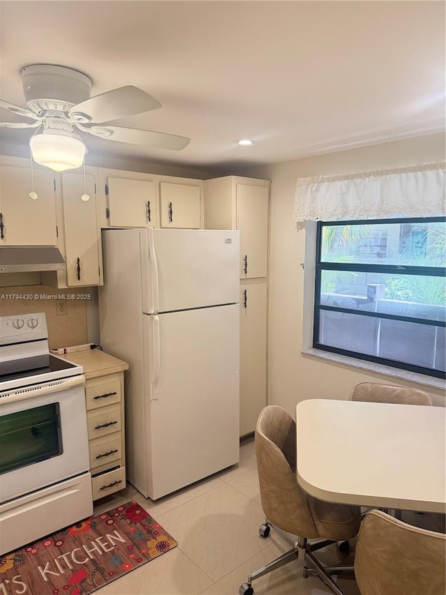 kitchen featuring light tile patterned flooring, white appliances, light countertops, under cabinet range hood, and a ceiling fan