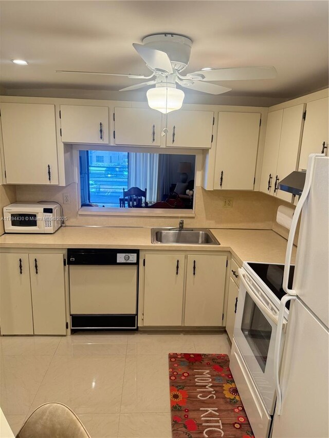 901 Colony Point Cir Unit 217, Pembroke Pines, FL 33026 - kitchen featuring light tile patterned floors, a sink, white appliances, under cabinet range hood, and light countertops