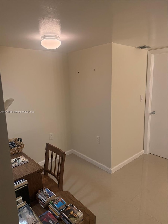 office space with baseboards and visible vents