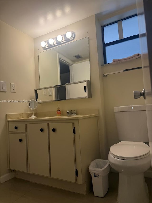 bathroom featuring tile patterned floors, vanity, toilet, and visible vents