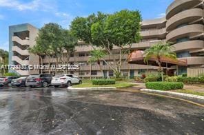 901 Colony Point Cir Unit 217, Pembroke Pines, FL 33026 - view of building exterior with uncovered parking