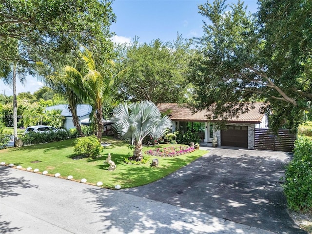 480 NW 88th Ter, El Portal, FL 33150 - view of front of property with a tiled roof, a garage, driveway, and a front yard