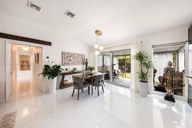 dining room featuring visible vents, light tile patterned floors, and vaulted ceiling
