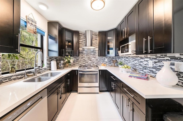 kitchen featuring a sink, white appliances, light countertops, wall chimney exhaust hood, and tasteful backsplash