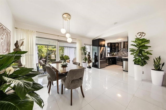 480 NW 88th Ter, El Portal, FL 33150 - dining room featuring light tile patterned flooring and vaulted ceiling
