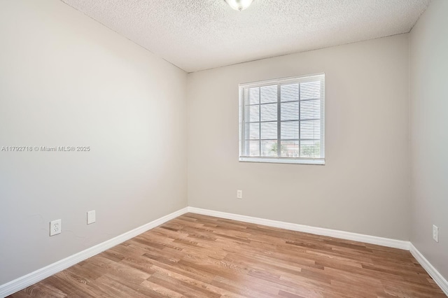 7451 SW 157th Ct, Miami, FL 33193 - unfurnished room featuring baseboards, light wood-type flooring, and a textured ceiling