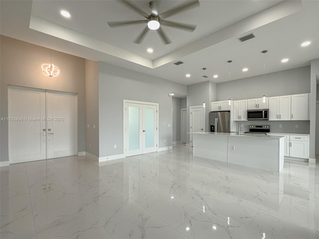 417 Paddock St, Lehigh Acres, FL 33974 - unfurnished living room featuring a sink, baseboards, recessed lighting, a ceiling fan, and a towering ceiling