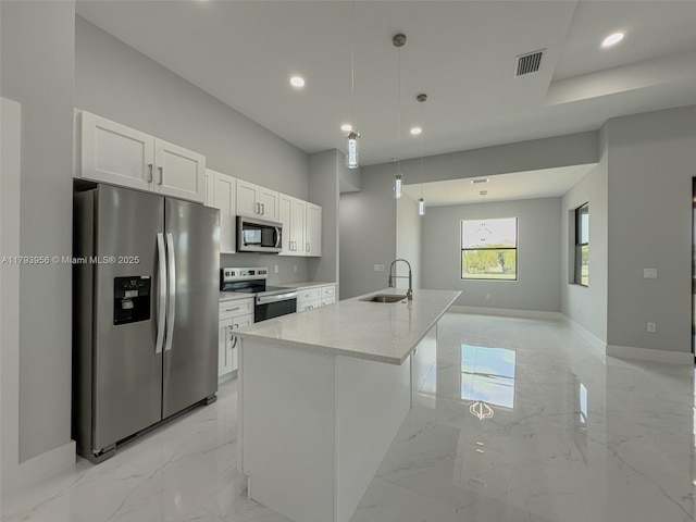 417 Paddock St, Lehigh Acres, FL 33974 - kitchen with stainless steel appliances, light marble finish flooring, a sink, recessed lighting, and white cabinetry