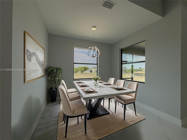 417 Paddock St, Lehigh Acres, FL 33974 - dining space with baseboards and a chandelier