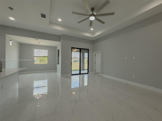 417 Paddock St, Lehigh Acres, FL 33974 - unfurnished room with light marble finish flooring, ceiling fan, baseboards, a tray ceiling, and recessed lighting