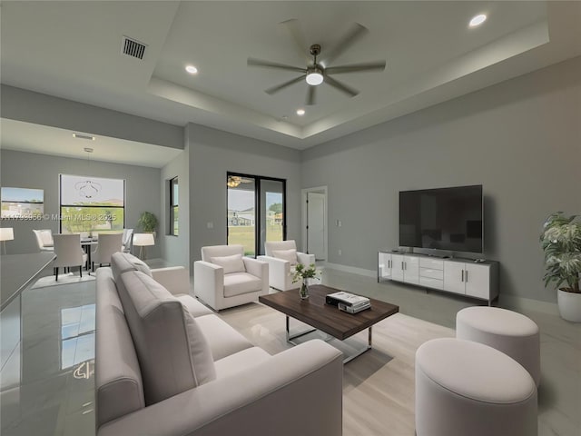 417 Paddock St, Lehigh Acres, FL 33974 - living area with a ceiling fan, a tray ceiling, plenty of natural light, recessed lighting, and baseboards
