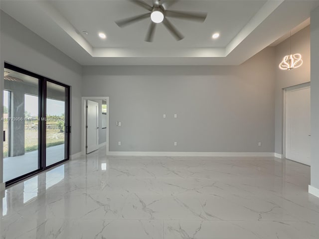 417 Paddock St, Lehigh Acres, FL 33974 - spare room with baseboards, a raised ceiling, ceiling fan, and recessed lighting