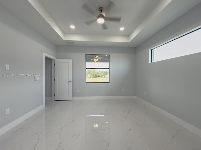 417 Paddock St, Lehigh Acres, FL 33974 - empty room featuring ceiling fan, baseboards, healthy amount of natural light, a tray ceiling, and recessed lighting