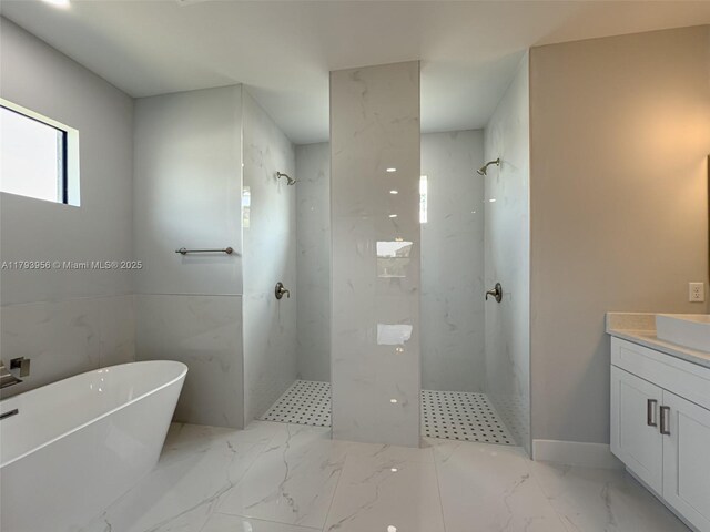 417 Paddock St, Lehigh Acres, FL 33974 - bathroom with a marble finish shower, marble finish flooring, a freestanding tub, and vanity