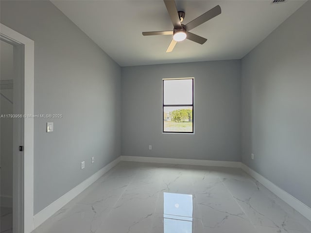 417 Paddock St, Lehigh Acres, FL 33974 - spare room featuring ceiling fan, light marble finish flooring, and baseboards