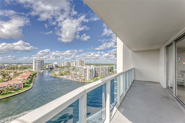 balcony featuring a city view and a water view
