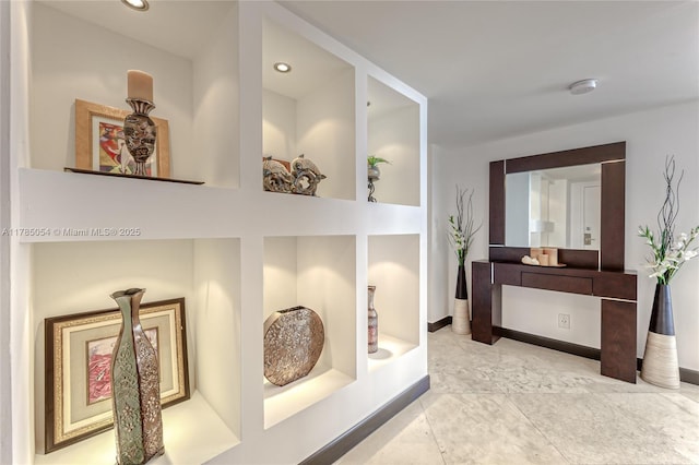 hall with recessed lighting and baseboards