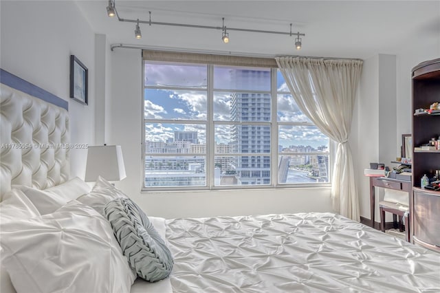 bedroom with a city view and rail lighting