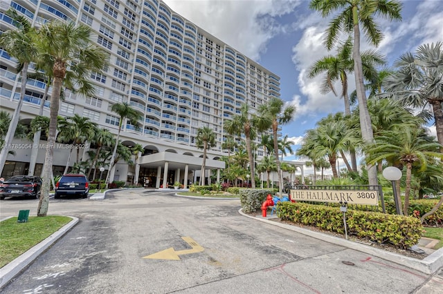 view of building exterior featuring uncovered parking