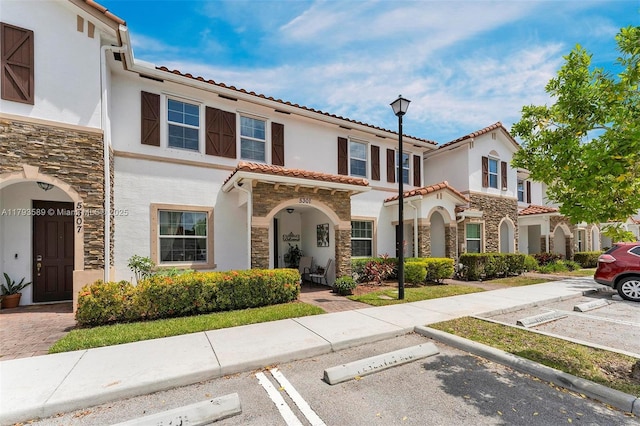 5301 Ellery Ter, West Palm Beach, FL 33417 - mediterranean / spanish home with uncovered parking, stucco siding, and stone siding