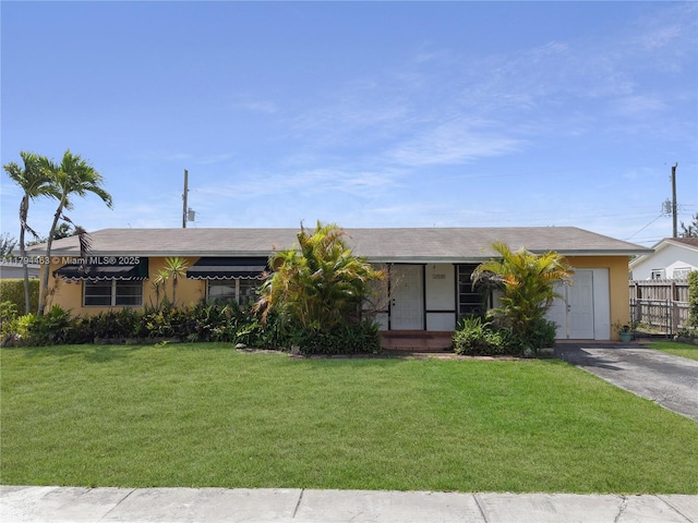 single story home with fence, stucco siding, and a front lawn