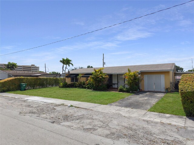 single story home with stucco siding, driveway, and a front yard