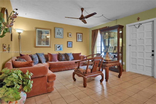living area with a ceiling fan and light tile patterned floors