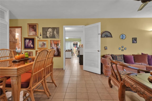 dining area with light tile patterned floors and a ceiling fan