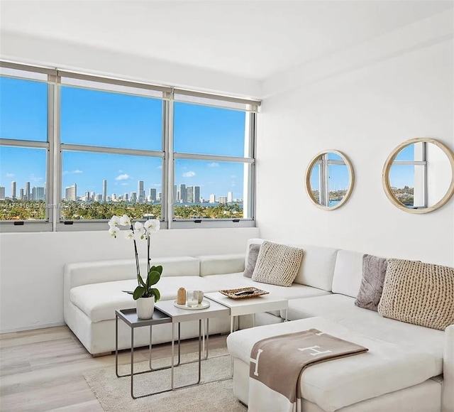 living area with a view of city and wood finished floors