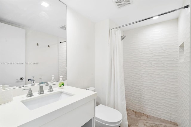 bathroom with vanity, toilet, curtained shower, and visible vents