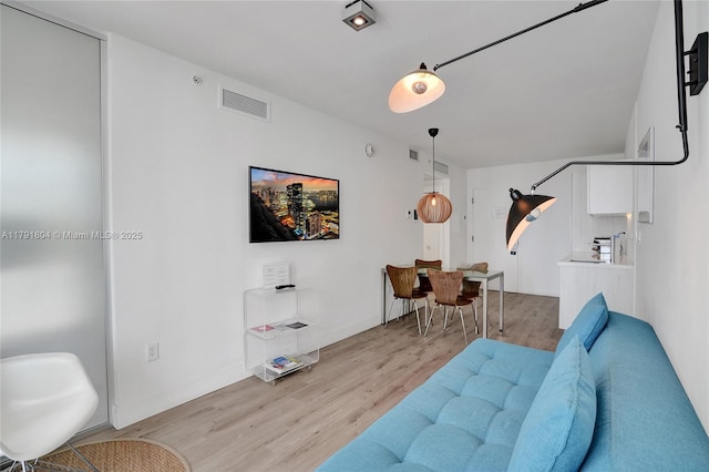 living area with visible vents and light wood-type flooring