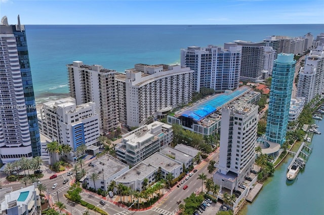 birds eye view of property featuring a water view and a city view