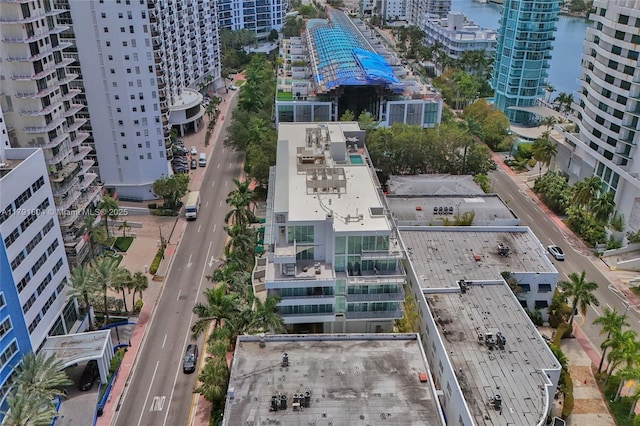 drone / aerial view featuring a view of city and a water view