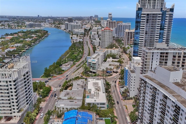 drone / aerial view featuring a view of city and a water view
