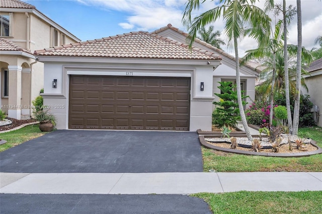 1371 Canary Island Dr, Weston, FL 33327 - mediterranean / spanish-style house featuring an attached garage, stucco siding, driveway, and a tiled roof