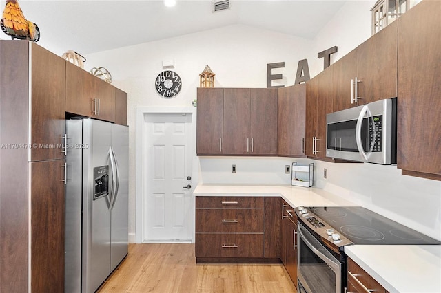 1371 Canary Island Dr, Weston, FL 33327 - kitchen with vaulted ceiling, light countertops, stainless steel appliances, and light wood-style flooring