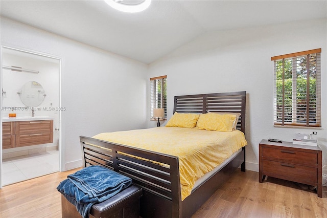 1371 Canary Island Dr, Weston, FL 33327 - bedroom with ensuite bath, baseboards, vaulted ceiling, and light wood-style floors