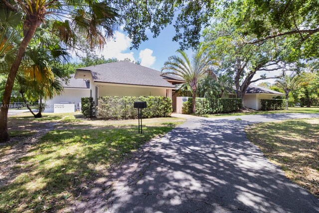 6255 SW 99th Ter, Pinecrest, FL 33156 - ranch-style house with a front lawn, stucco siding, and driveway