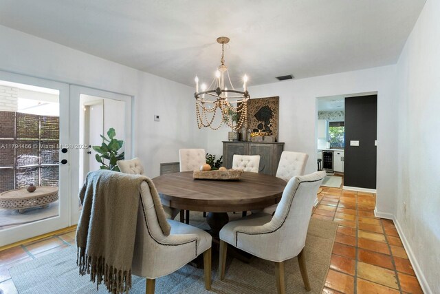 6255 SW 99th Ter, Pinecrest, FL 33156 - dining space with light tile patterned flooring, baseboards, an inviting chandelier, and visible vents