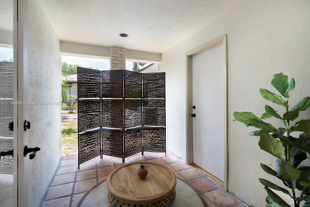 exterior space featuring a textured wall