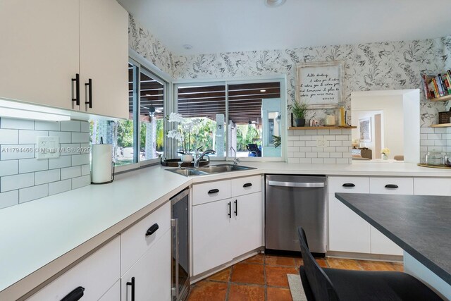 6255 SW 99th Ter, Pinecrest, FL 33156 - kitchen featuring decorative backsplash, stainless steel dishwasher, a sink, wine cooler, and wallpapered walls