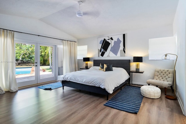 bedroom with access to exterior, french doors, baseboards, wood finished floors, and vaulted ceiling