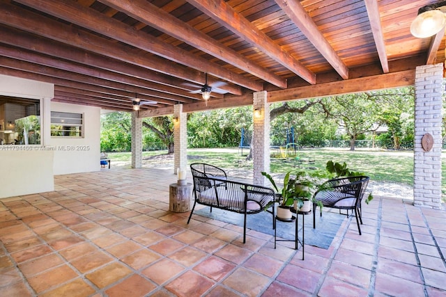 view of patio / terrace with ceiling fan and fence