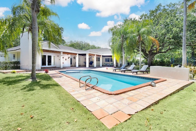 pool with a patio and a yard