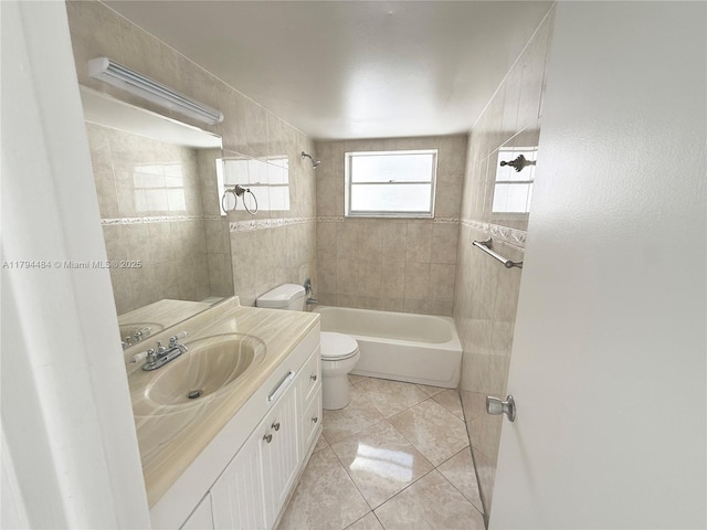 bathroom featuring vanity, washtub / shower combination, tile patterned flooring, and toilet