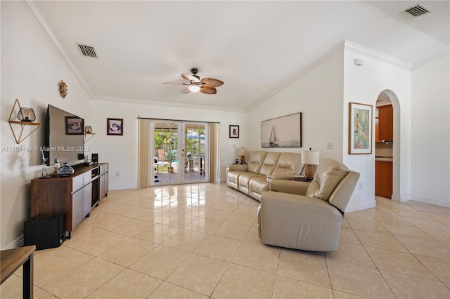 living room featuring visible vents, ornamental molding, arched walkways, and a ceiling fan