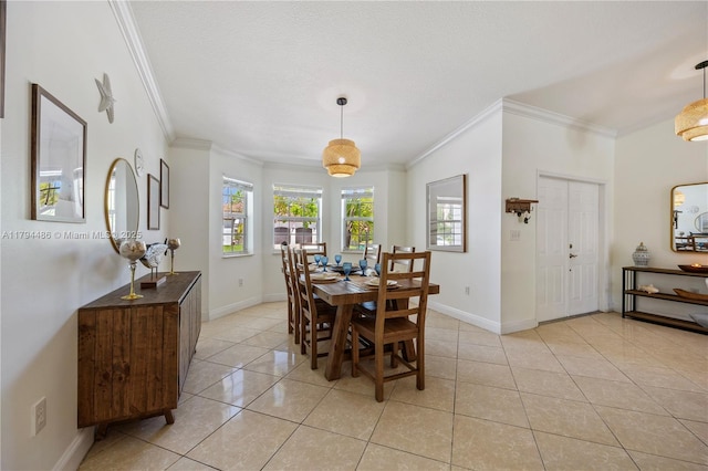 dining area featuring crown molding, light tile patterned flooring, and baseboards