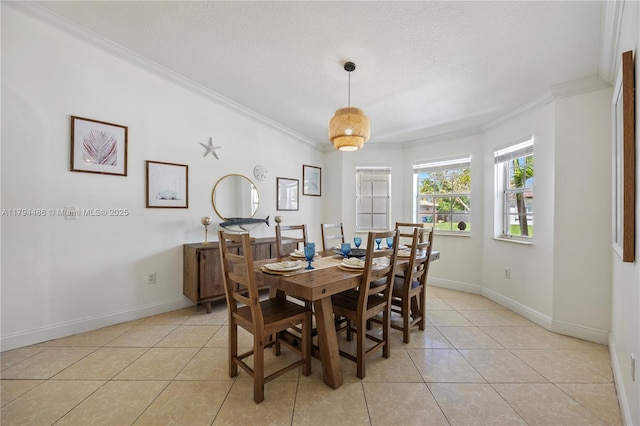 dining area featuring crown molding, a textured ceiling, baseboards, and light tile patterned flooring